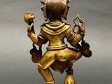 bronze statue of a person holding a bird on a pedestal