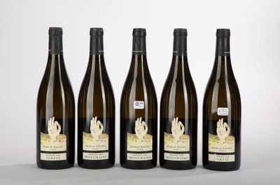 four bottles of wine are lined up on a table