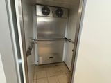 a stainless steel refrigerator in the corner of a room