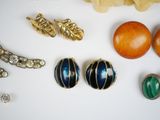 many different types of jewelry on a white surface