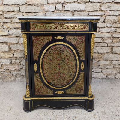 a black and gold cabinet with a marble top