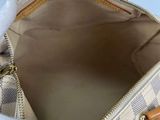 the inside of a louis vuitton handbag with a white glove