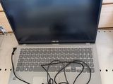 a laptop computer sitting on top of a table with a charger