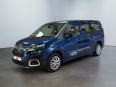 the blue van is parked in a room with a white wall