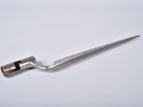 a small metal tool that is on a white surface
