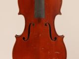 an old violin with a bow hanging from it ' s back