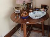 a small table with a bowl on it and a lamp on it