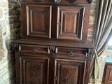 a large wooden cabinet in the corner of a room
