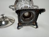 a silver plate and a silver cup on a table