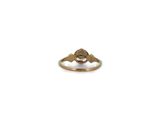 a close up of a gold ring with a bird on it