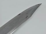 a large knife that is laying on a table