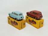 three toy cars are sitting on top of boxes on a white surface