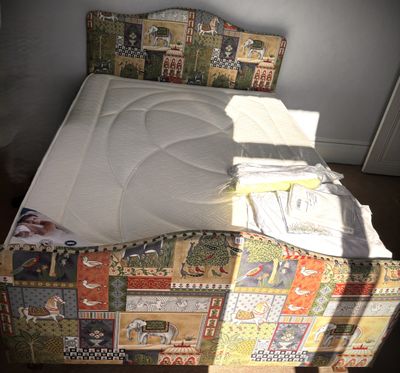 a bed that has a mattress on top of it
