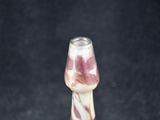 a glass vase that has a pink and white design on it