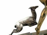 bronze statue of a woman and a dog on a wooden base