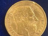 a close up of a gold coin on a blue cloth