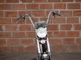 a close up of a motorcycle parked in front of a brick wall