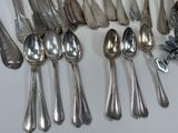 a lot of silver spoons and spoon spoons on the table