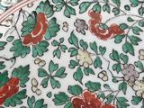 a plate with flowers on it sitting on a table