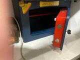 a microwave oven with a red door and a red handle