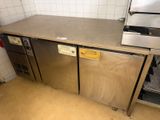 a stainless steel counter top in a kitchen with a dishwasher and oven