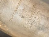 a close up of a silver vase on a table