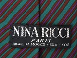 green and purple striped neck tie with a name tag on it