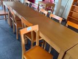 tables and chairs in a room with a red wall and blue carpet