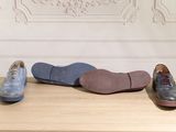 three pairs of shoes sitting on a table next to each other