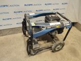 an electric pressurer sitting on top of a cart in front of a wall