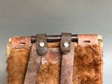 an image of a brown leather purse with two leather straps