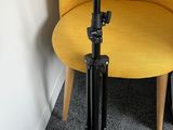 a yellow chair with a tripod on it next to a yellow chair