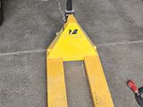 a fork lifter sitting on the ground in a garage