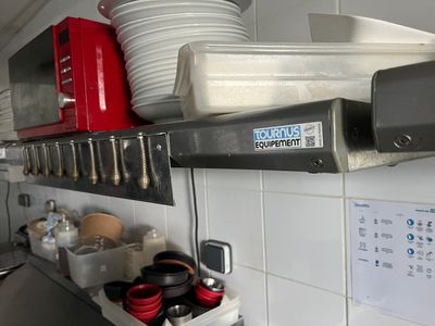 a shelf with dishes and bowls on it in a kitchen
