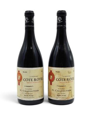 two bottles of wine sitting next to each other on a white surface