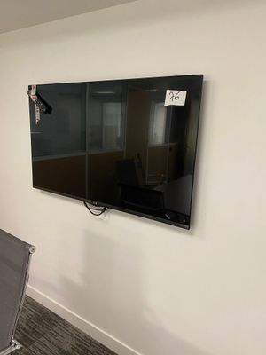 a flat screen tv mounted on the wall in a room