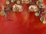 a red wall with a bunch of brass objects on it