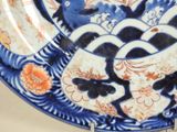 a blue and white plate with a fish design on it