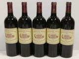 six bottles of wine are lined up on a table