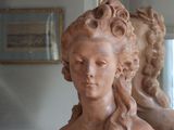 a statue of a woman that is sitting on a table
