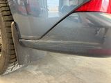 a close up of a car ' s rear end with a flat tire