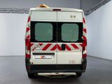 a white van with red and white stripes parked in a room