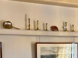 many framed pictures on the wall of this room