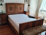 a bed with a wooden headboard and foot board in a room