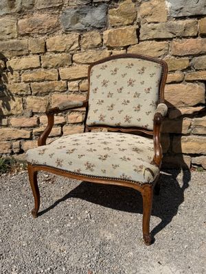 a chair that is sitting in front of a stone wall