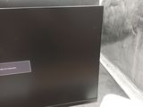 a computer monitor sitting on top of a table