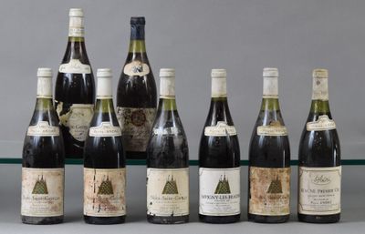 several bottles of wine are lined up on a glass shelf