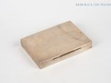 an image of a small silver box on a white surface