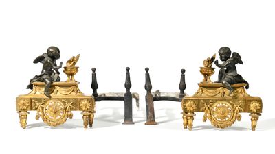 pair of antique bronze figurines of cherensils on a table