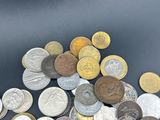 a pile of coins sitting on a table with a black background